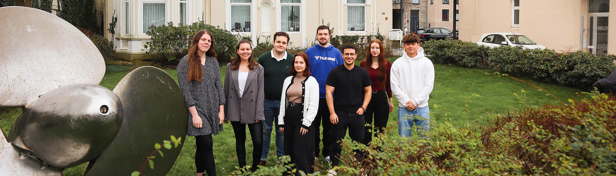 Trainees at FRS in front of the ship's propeller