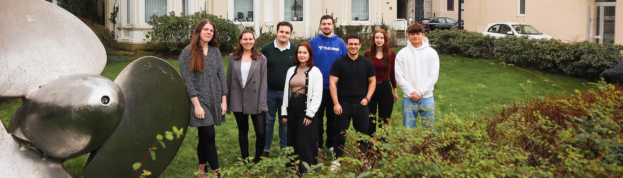 Trainees at FRS in front of the ship's propeller
