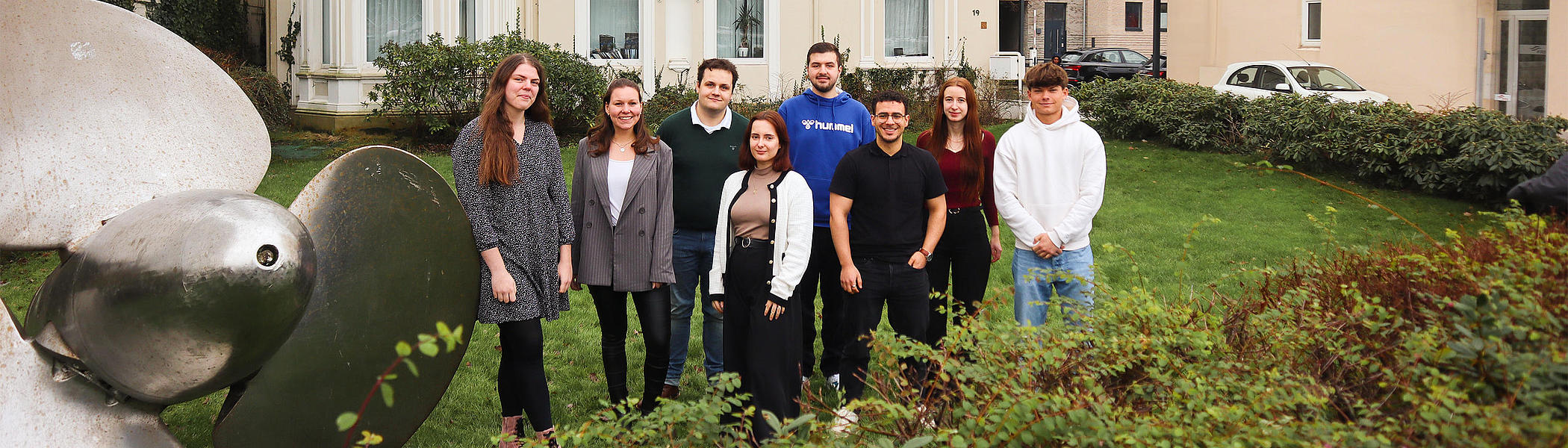Trainees at FRS in front of the ship's propeller