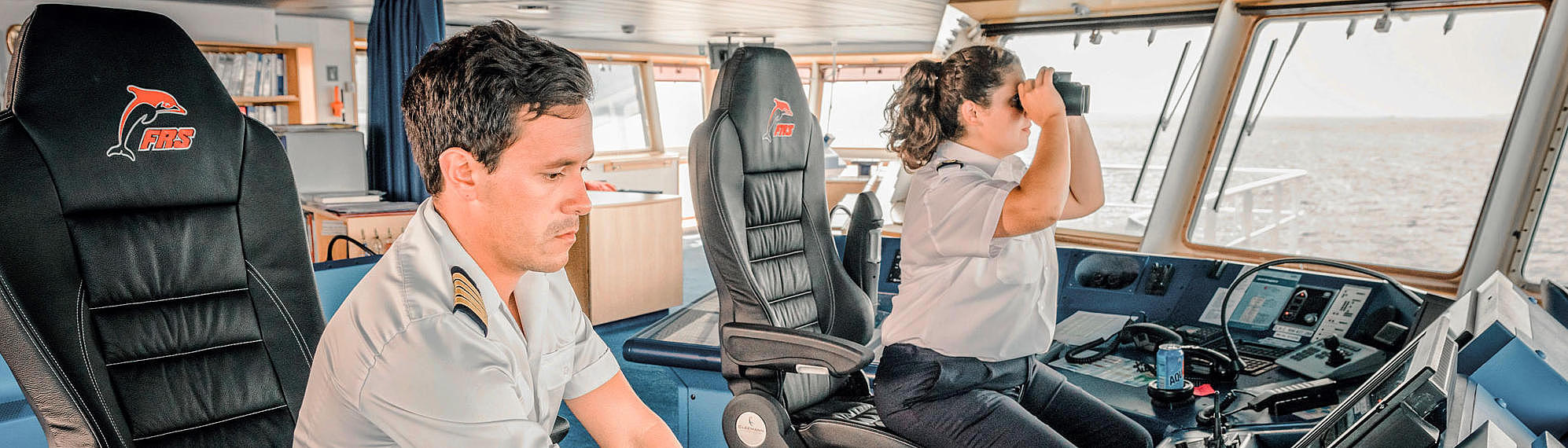 Male and female captain on the bridge of the HSC Tarifa Jet.