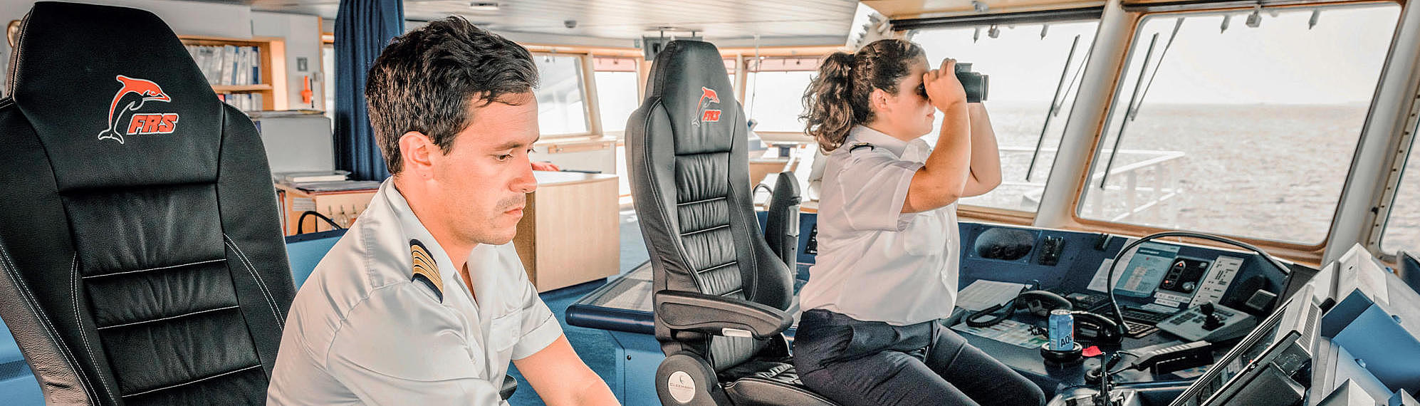 Male and female captain on the bridge of the HSC Tarifa Jet.
