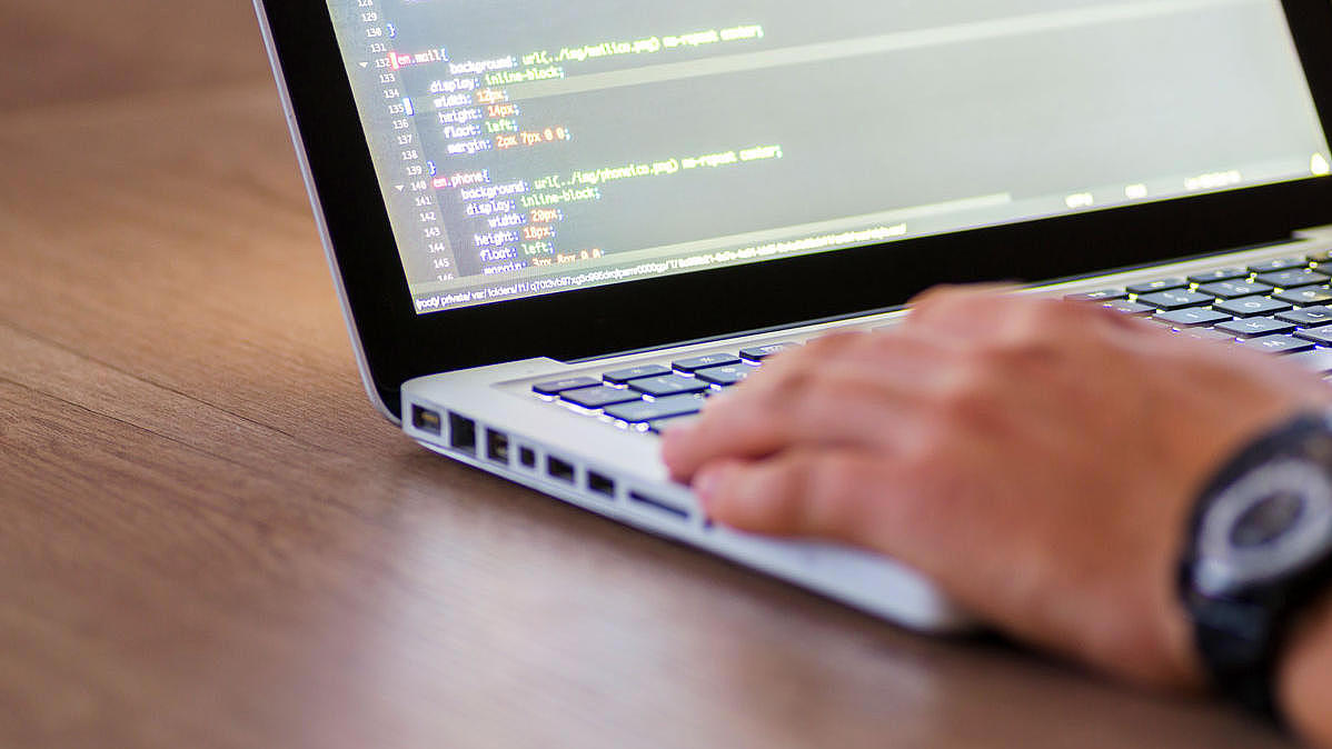 A person programming on a notebook.