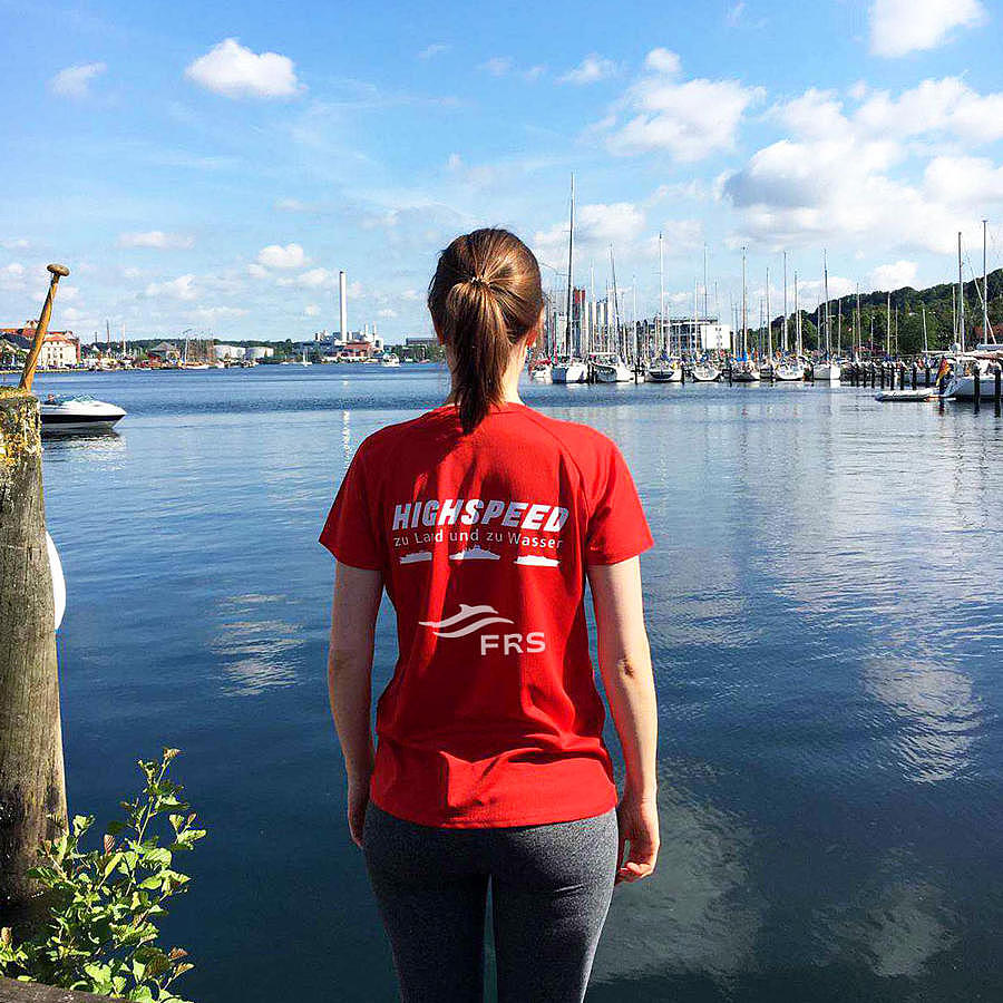 employee standing infront of water, looking into the distance
