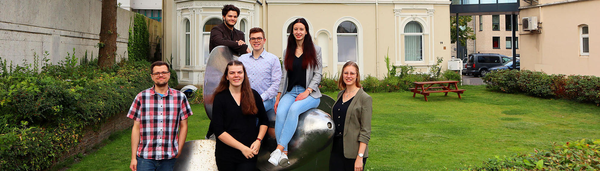 Apprentices standing around a propeller.