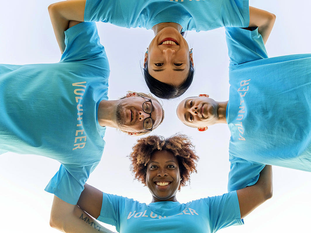 four volunteers, who are forming a human circle.