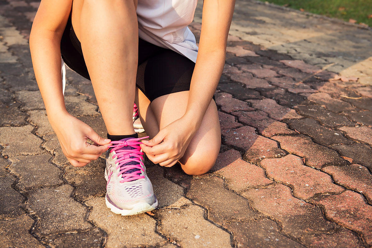 A woman lacing her shoes